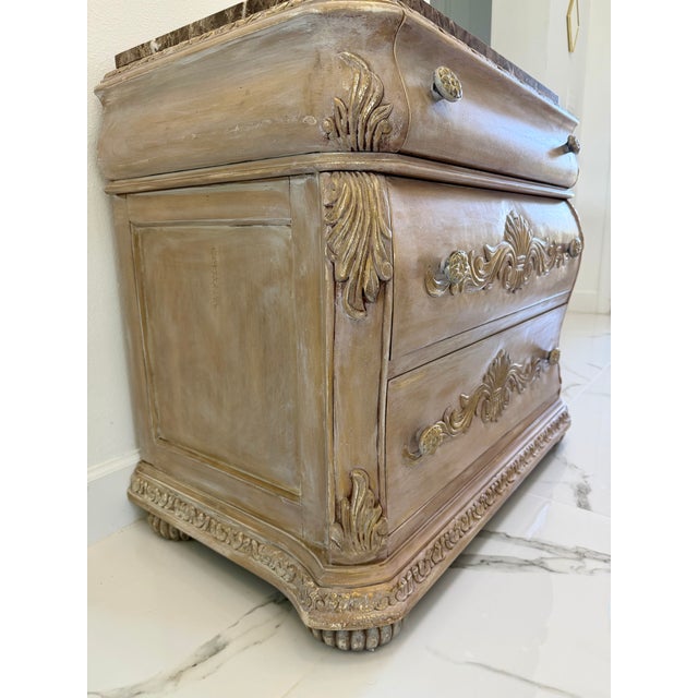 This is a beautifully antiqued French Provincial/Louis XV-style bombe chest, boasting a warm, neutral, distressed finish...