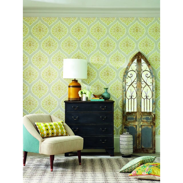 In a fresco style and reminiscent of Indian block prints this mirrored ogee trellis wallpaper is filled with decorative...