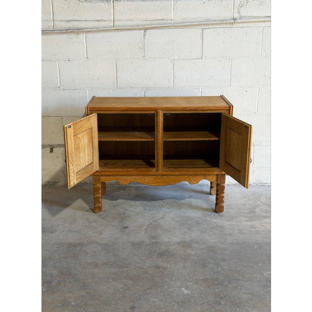 Beautiful vintage Danish oak cabinet in the style of Henning Kjærnulf, featuring richly grained solid oak, decorative...