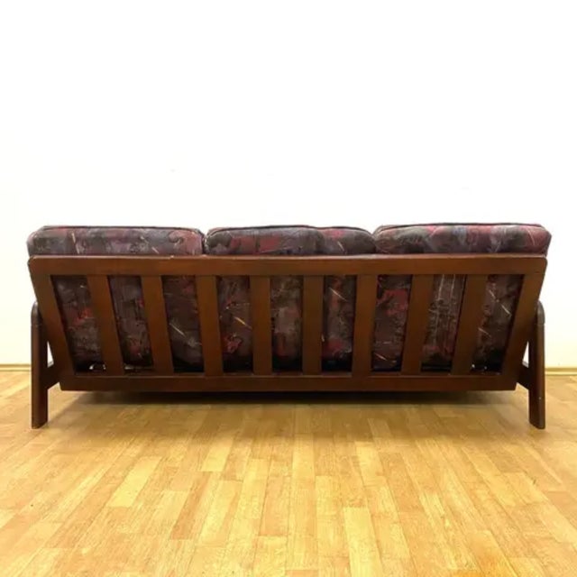 A stylish retro sofa produced in the second half of the 20th century, featuring a solid wooden frame, removable...