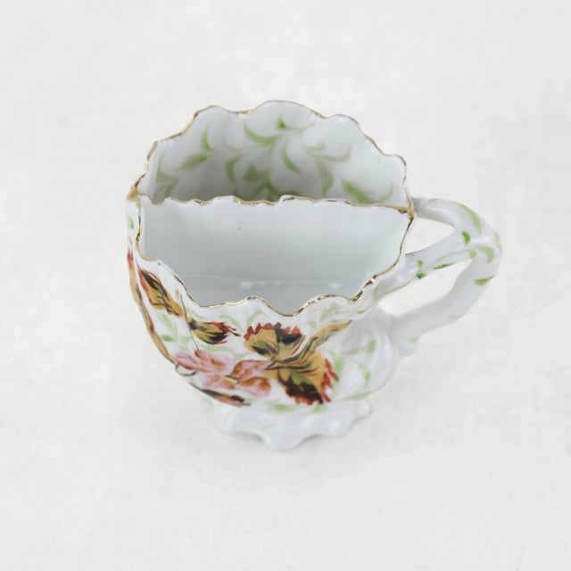 Add a touch of vintage charm to your bathroom with this antique porcelain shaving mug, beautifully adorned with hand-...