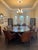 Twelve custom mahogany upholstered armchairs, this sophisticated set combines striking architectural design with timeless...