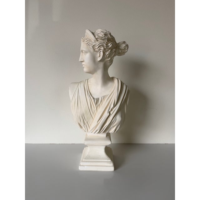 Elegant neoclassical bust sculpture inspired by the iconic “Diana of Versailles,” representing Diana, the Roman goddess of...