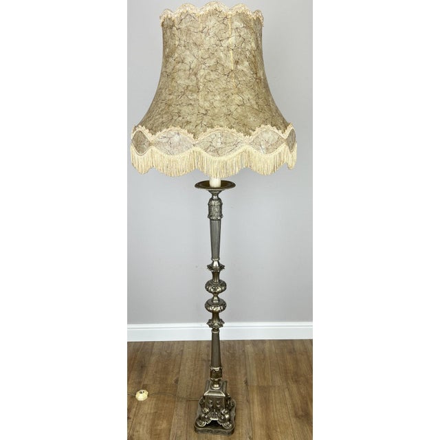 A stunning Vintage French standing lamp featuring an elegant ornate metal base and a beautifully shaped decorative fabric...