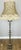 A stunning Vintage French standing lamp featuring an elegant ornate metal base and a beautifully shaped decorative fabric...