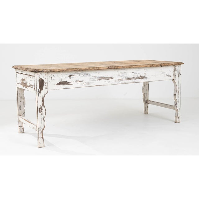 The 1900s French Wood Patinated Dining Table is a splendid artifact that embodies the essence of a bygone era. Its robust...