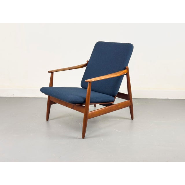 A delicate teak armchair, designed by Hans Olsen for Frem Røjle of Denmark. Crafted to a high standard with fine details....