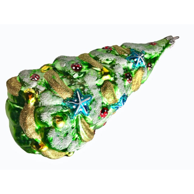 A striking large hand blown mercury glass tree ornament embellished with hand painted colors and glitter. Marked "West...