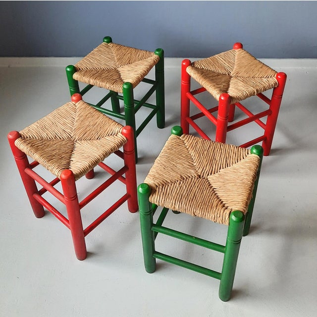 Colorful set of 4 low stools (2 green, 2 red). Wood with rush seat. The stools are made of a light type of wood with a...
