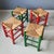 Colorful set of 4 low stools (2 green, 2 red). Wood with rush seat. The stools are made of a light type of wood with a...