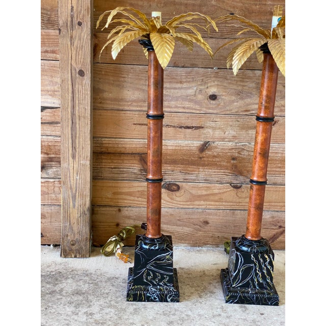 Regency gold palm leaf faux bamboo Torchiere table lamps with black faux marble bases by Raymond Waites for Tyndale. No...