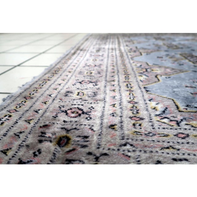 A handmade vintage Uzbek Bukhara rug from the 1950s, woven in wool and showcasing the refined tribal aesthetic...