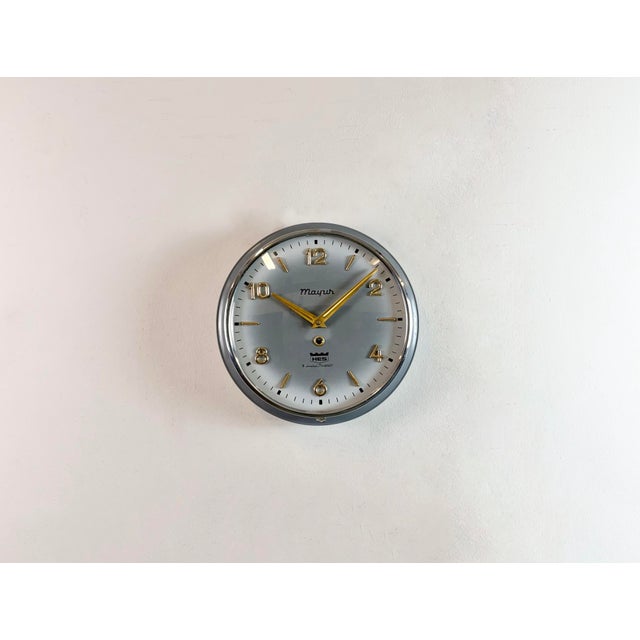 Vintage winding wall clock (model Mayur) made by HES in India during the 1960s.It features a grey metal body and a convex...