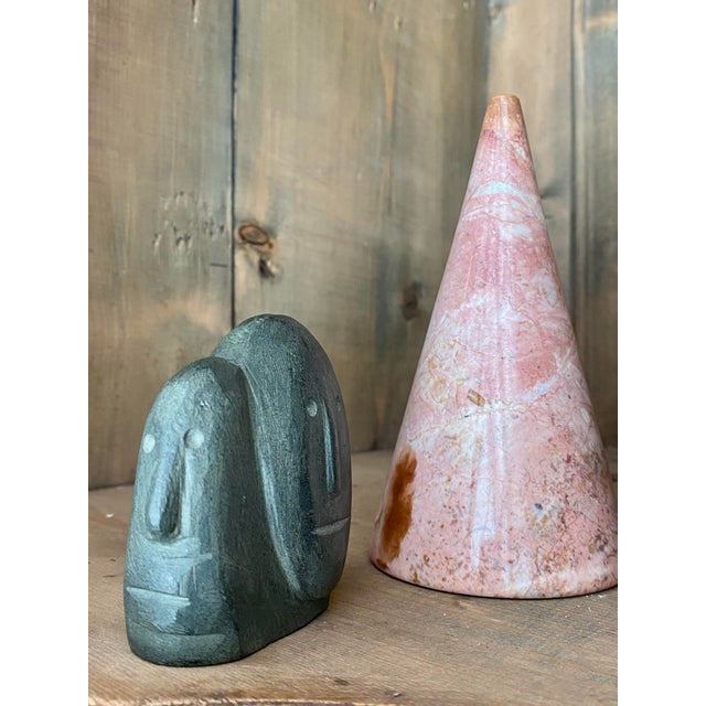 A fine mid 20th C. Inuit sculpture from a remote Arctic village. A very lively expressive carving of two faces in basalt...