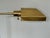 Late 20th century polished brass pharmacy floor lamp with an adjustable height stem and a rectangular hooded shade....