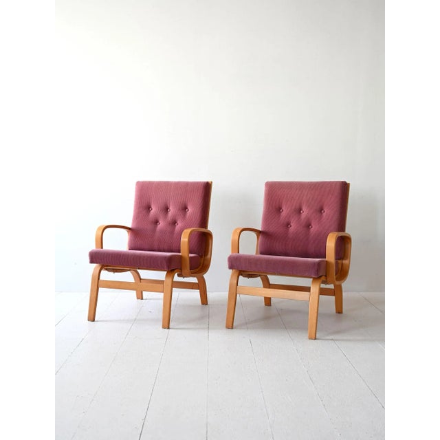 Set of two 1960s Scandinavian armchairs with curved laminated wood structure. The padded parts are in good condition and...
