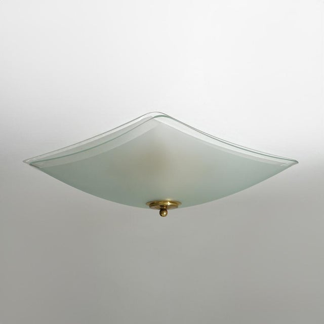 A 1970s ceiling light that explores glass as a sculptural material as much as a functional diffuser. The square panel is...