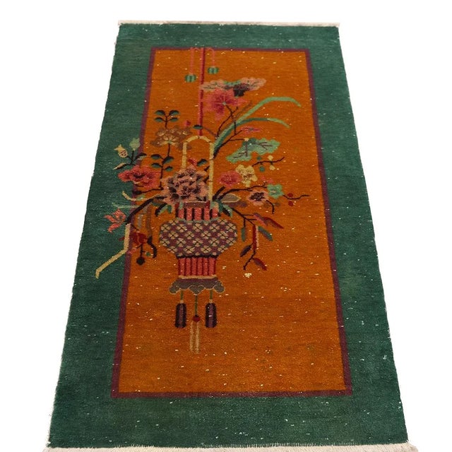 This exquisite rug&nbsp;features a striking orange-yellow hue with vibrant green borders, adding a touch of elegance to...