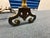 This antique brass and iron fireplace set includes a beautifully crafted pair of andirons topped with turned brass finials...