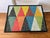Custom Made coffee table features a colorful geometric shapes mosaic tile top. The surface is composed of triangular...