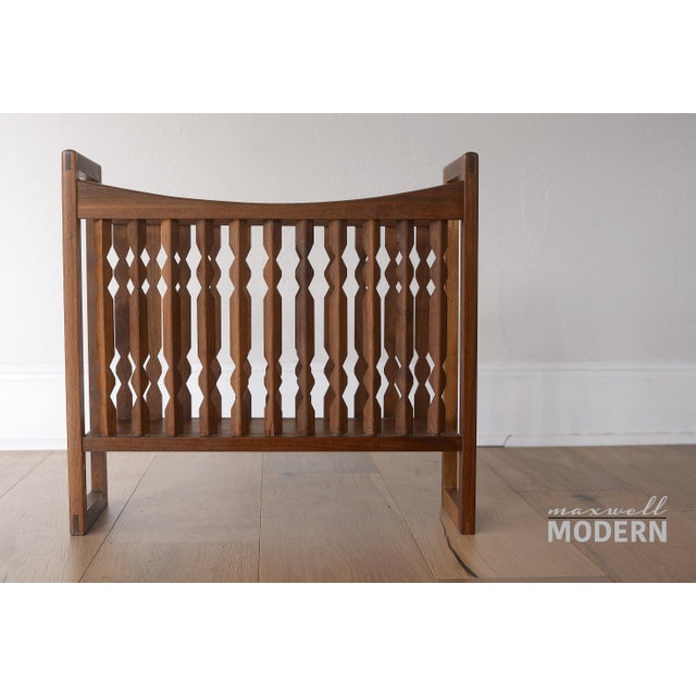 Beautiful mid century magazine rack designed by Arthur Umanoff with solid walnut notched spindles for Washington Woodcraft.