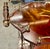Striking mid-century Italian bar or serving cart featuring richly figured wood veneers, decorative marquetry and elegant...