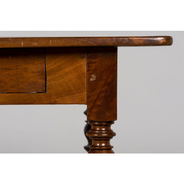 A beautiful mid-19th-century French Louis Philippe writing table, sourced in Provence, France. Crafted from walnut, the...