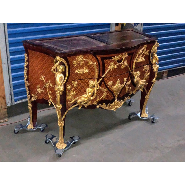 This fine commode is made of real solid wood and parquetry inlays. Has two shaped drawers with the handles forming a...