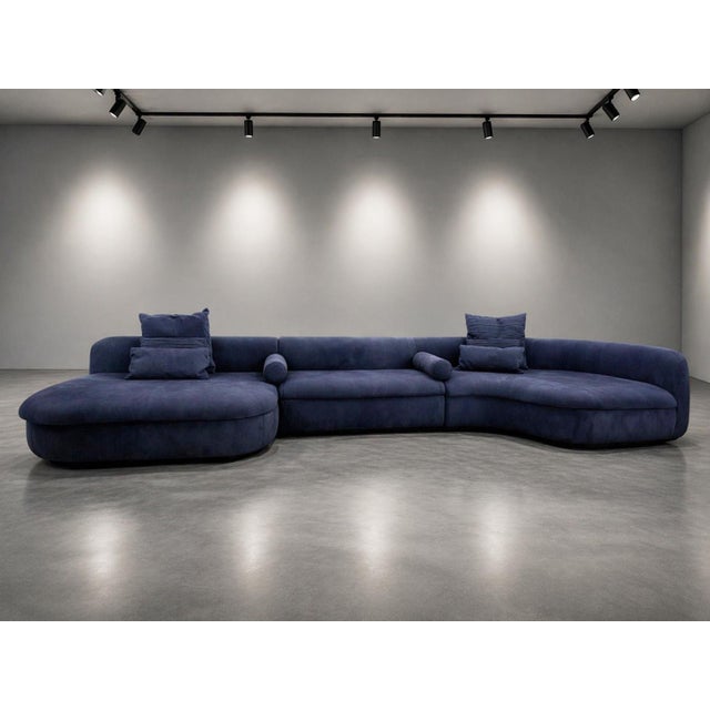 A sculptural and highly sought-after “Piaf” sectional sofa by Baxter, crafted in Italy and upholstered in sumptuous blue...