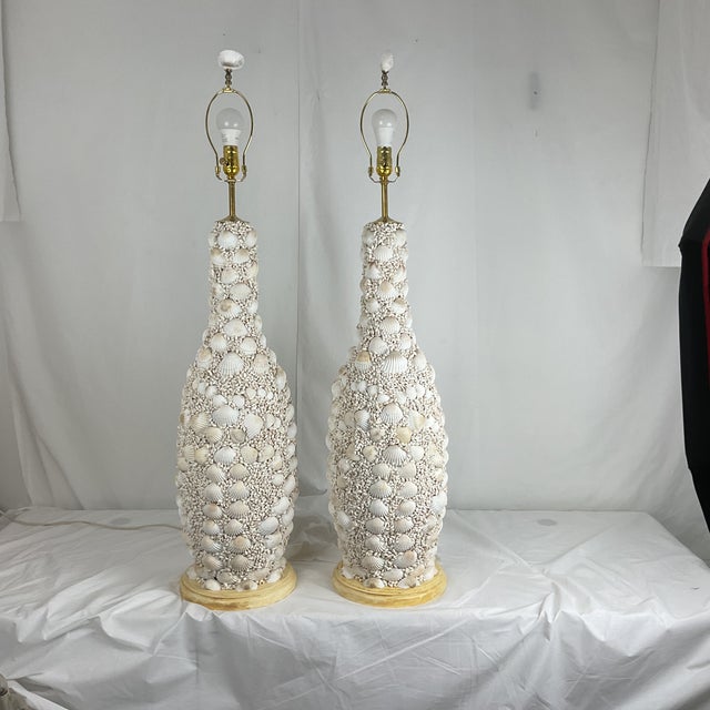 Beautiful pair of coastal‑style table lamps featuring intricately hand‑applied seashell bases. Each lamp showcases a...