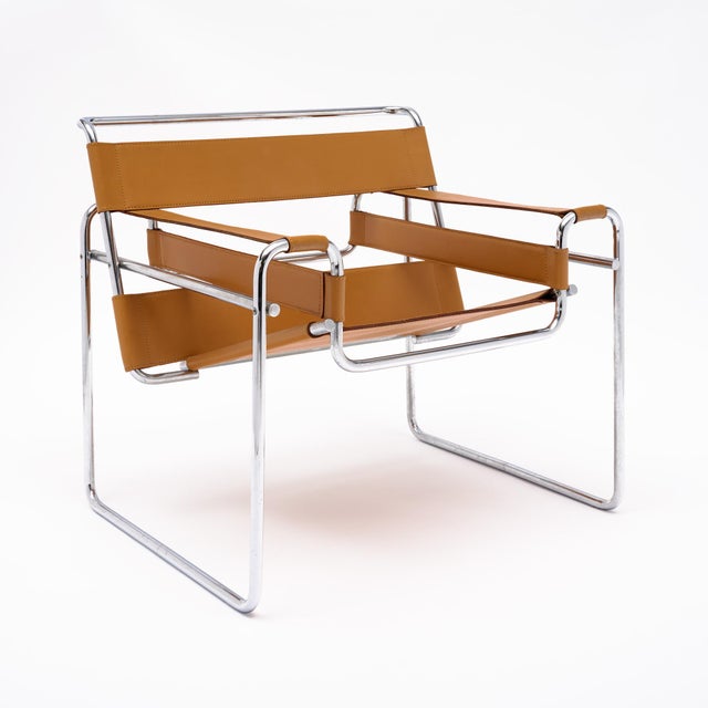 Marcel Breuer’s famous armchair Wassily design. This chair is made of tan leather and chromed steel in the iconic chair...