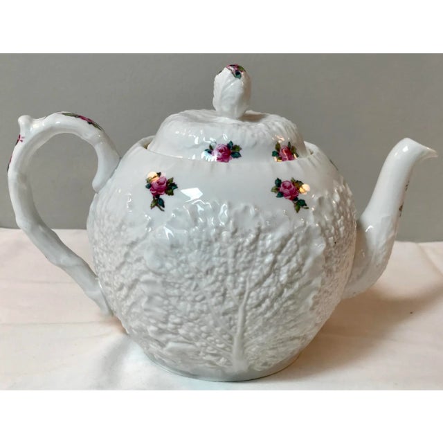 This gorgeous and rare teapot by Spode is in the Bridal Rose pattern. The body is moulded with veined cabbage leaves with...
