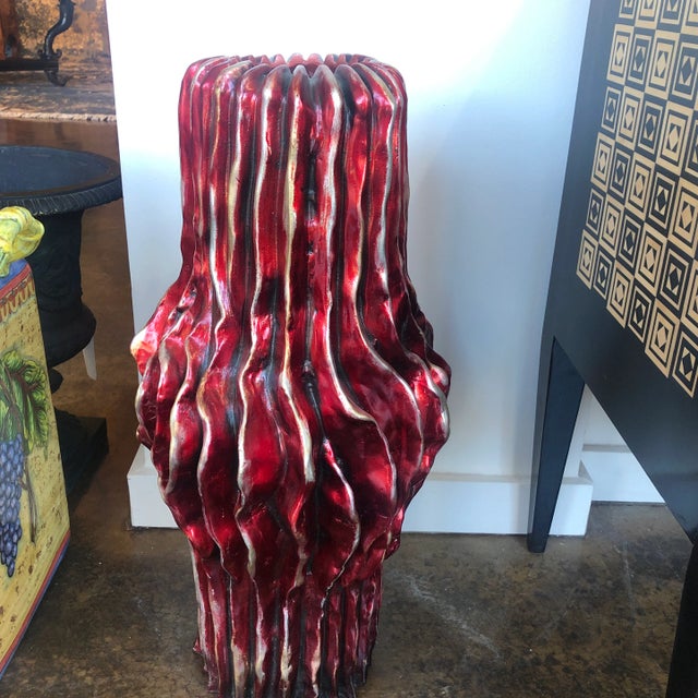 Pair of tall vases featuring a contemporary rustic style ridged design and a crimson red glazed finish. Created by the...