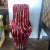 Pair of tall vases featuring a contemporary rustic style ridged design and a crimson red glazed finish. Created by the...