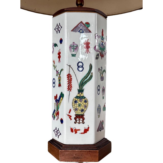 This vintage Chinese porcelain lamp features a hexagonal body with hand-painted famille rose panels depicting florals and...