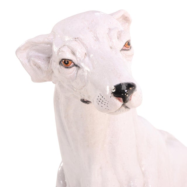 A charming Italian majolica figure of a dog skillfully modeled and decorated in richly glazed earthenware. Capturing the...