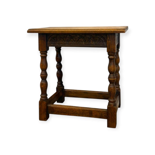 This vintage-style wooden side table features hand-carved fan arches along the apron and turned baluster legs anchored by...
