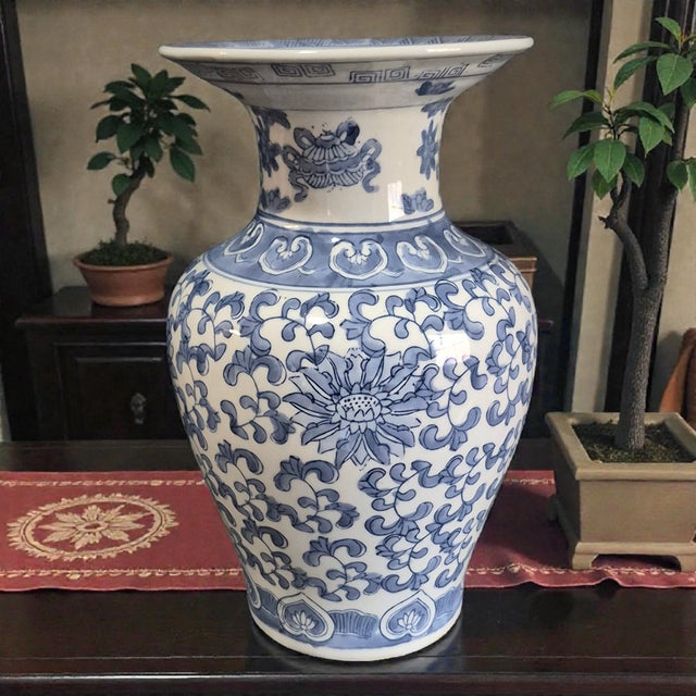 This vintage Chinese porcelain blue and white vase bears the "Jiaging Nian Zhi" mark in the Qing style. Originating from...