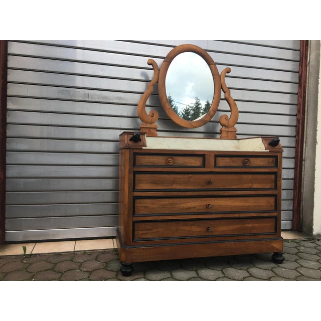 Dressing table with mirror from the nineteenth century in walnut. The furniture was renovated and applied to the cleaned...