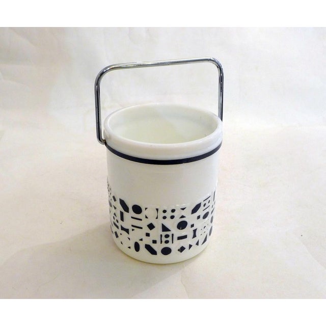 Cylindrical ice bucket with a body decorated with small geometric patterns and a raised graphic frieze, large chrome...