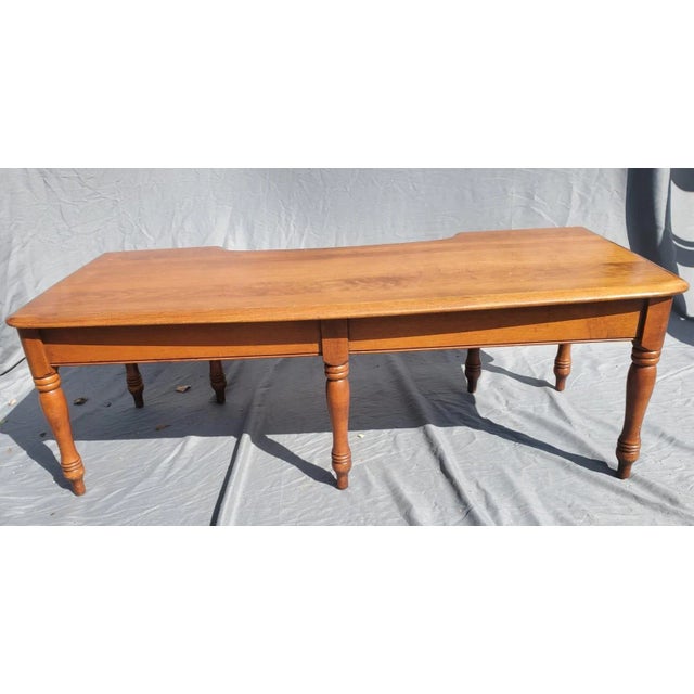 High quality American construction defines this solid maple drop leaf coffee table with one drawer. This coffee table is...