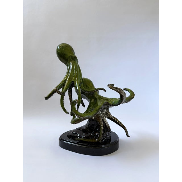 This contemporary bronze sculpture depicts a pair of intertwined octopuses, masterfully cast in bronze and finished in a...