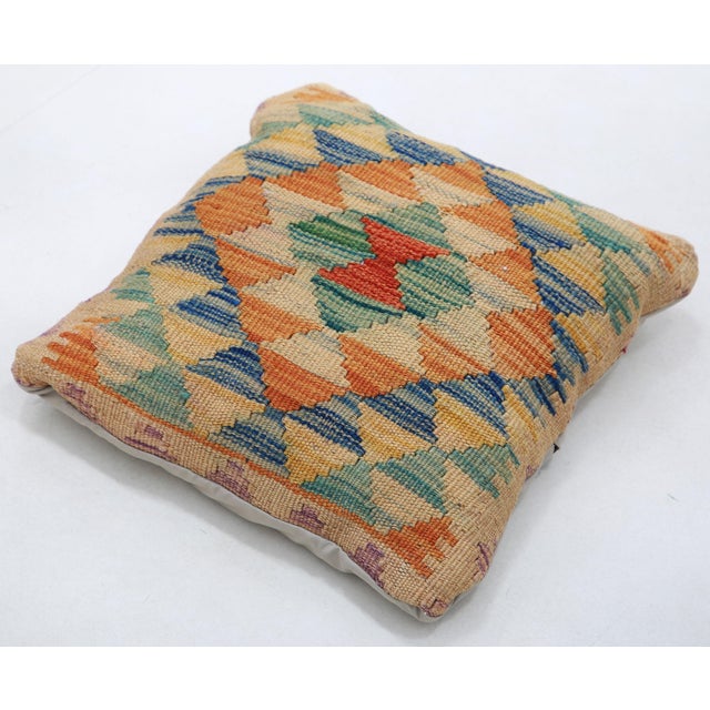 A one-of-a-kind handwoven Afghan wool kilim accent pillow featuring diamond lattice. Cut and sewn by hand from a flat-...