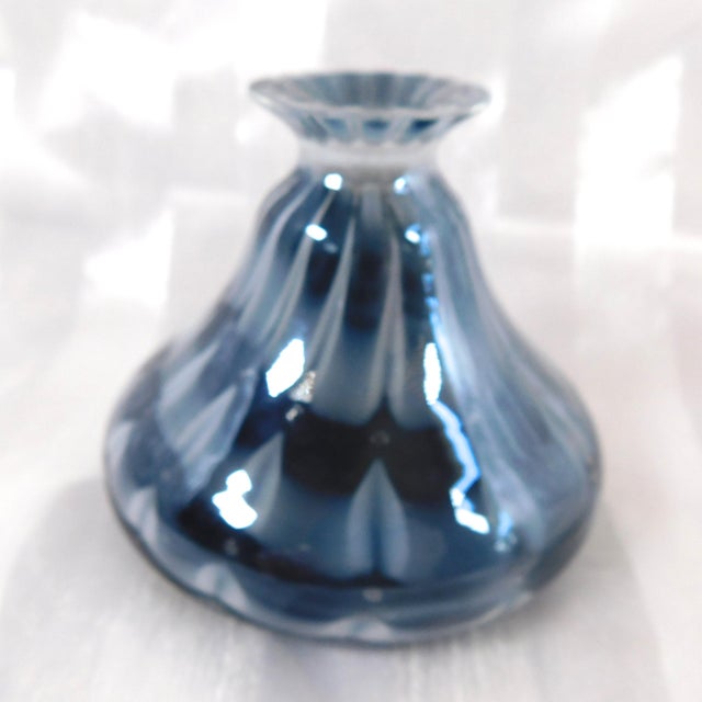 This is an unmarked black, white, and gray art glass perfume bottle in an pulled design. It has a clear stoppper that fits...