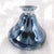 This is an unmarked black, white, and gray art glass perfume bottle in an pulled design. It has a clear stoppper that fits...