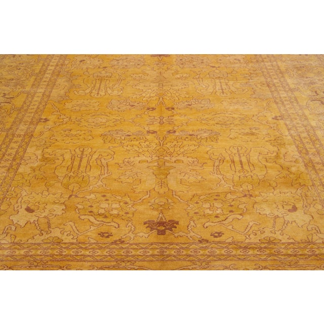 This hand-knotted wool rug boasts a beautiful vintage Indian design featuring a goldenrod color field color accentuated...