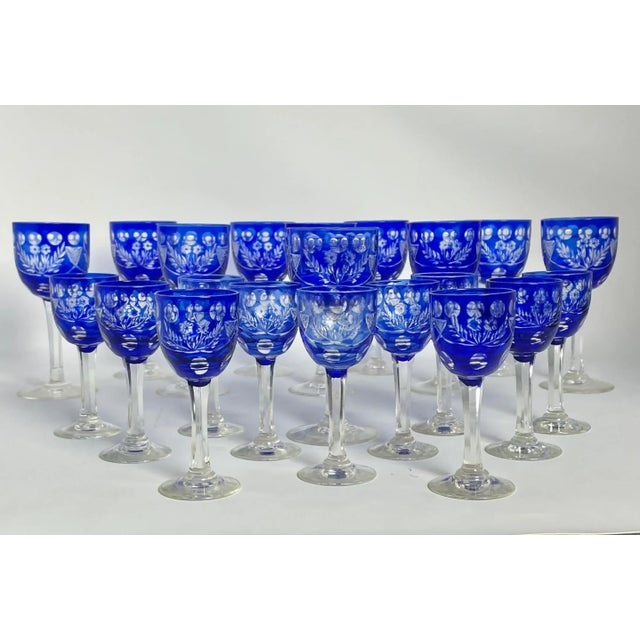 Striking set of Mid 20th Century Bohemian Czech cobalt blue cut-to-clear crystal stem glasses. Hand cut floral-foliate...