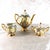 This is a thirteen piece tea set in white with a lot of other colors, a lot of gold trim and naked people on it. It...