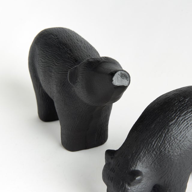 The little one explores, as the momma looks on, these modern polar bear sculptures really bring the charm. Sandcasted by...