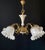 The chandelier is made of brass with a finish—featuring beautiful artistic wroughtwork. It is adorned with porcelain...